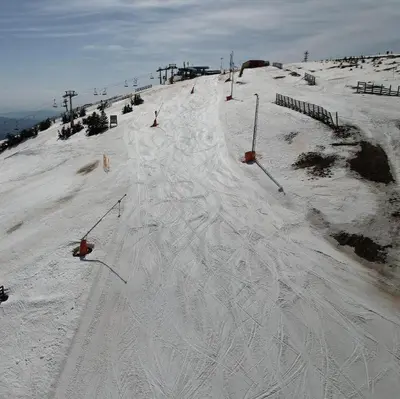 a snow covered ski slope with a person skiing down it at Woodside Kopaonik 417-418 in Kopaonik