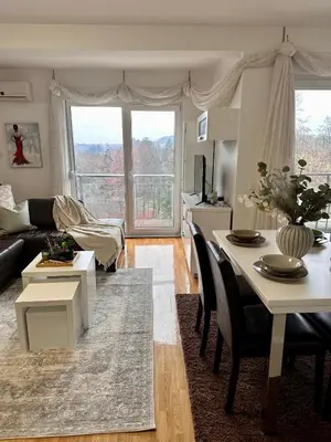 a living room with a couch and a table at Prelep Pogled, Elegantan Komfor Blizu Centra, Besplatan Parking, Apartman Floresta in Vrnjačka Banja