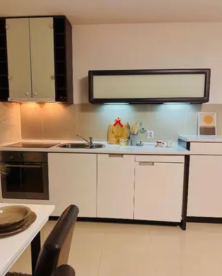 a kitchen with white cabinets and a sink at Prelep Pogled, Elegantan Komfor Blizu Centra, Besplatan Parking, Apartman Floresta in Vrnjačka Banja