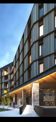 a large building with people walking in front of it at Woodside Duplex Apartment Ski in Ski out with garage in Kopaonik