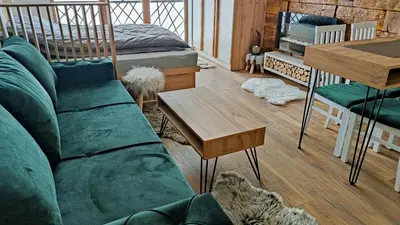 a living room with a couch and a table at President Kop apartmani Vista & Sol in Kopaonik