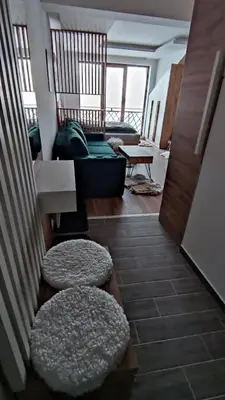 a living room with a couch and a table at President Kop apartmani Vista & Sol in Kopaonik