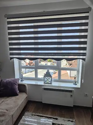 a living room with a large window with a blind at Apartments Myna in Kraljevi Cardaci in Kopaonik