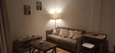 a living room with a couch and a table at Apartman Ema, Kopaonik, Brzeće - BLIZU GONDOLE in Brzeće