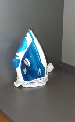 a blue and white iron sitting on a floor at Apartman Ema, Kopaonik, Brzeće - BLIZU GONDOLE in Brzeće