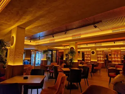 a restaurant with tables and chairs in a room at Euphoria Milmari Resort Kopaonik in Kopaonik