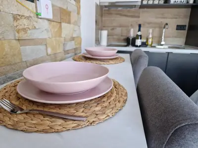 a counter with two bowls and plates on it at Euphoria Milmari Resort Kopaonik in Kopaonik