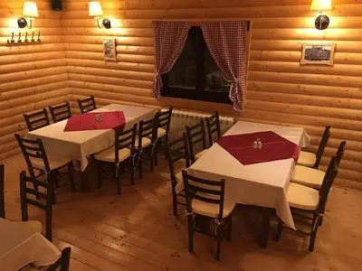 a dining room with tables and chairs with red napkins at BB Apartment 301, Župa Apartments in Kopaonik