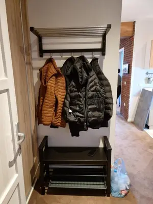 a group of jackets hanging on a wall at BB Apartment 301, Župa Apartments in Kopaonik