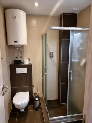 a small bathroom with a toilet and a shower at BB Apartment 301, Župa Apartments in Kopaonik
