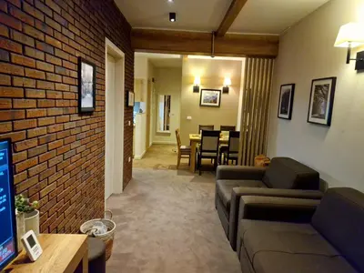 a living room with a couch and a brick wall at BB Apartment 301, Župa Apartments in Kopaonik