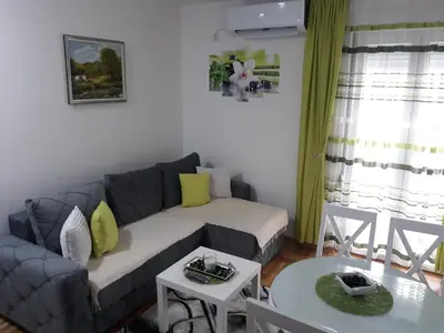 a living room with a couch and a table at Tanja Raj in Vrnjačka Banja