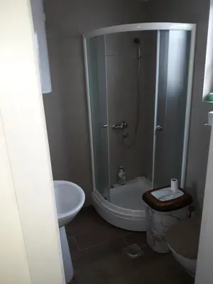 a bathroom with a shower and a toilet and a sink at Tanja Raj in Vrnjačka Banja