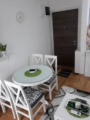 a white table and chairs in a living room at Tanja Raj in Vrnjačka Banja