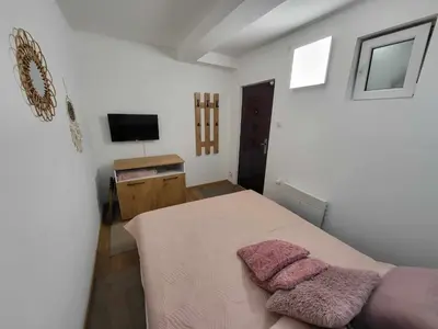 a bedroom with a bed with two pillows on it at Apartman Nina, Kopaonik, Brzeće, Kod Gondole in Brzeće