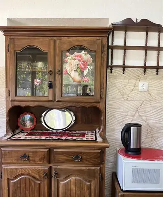 a wooden cabinet with a mirror on top of it at Green Village Life in Katun