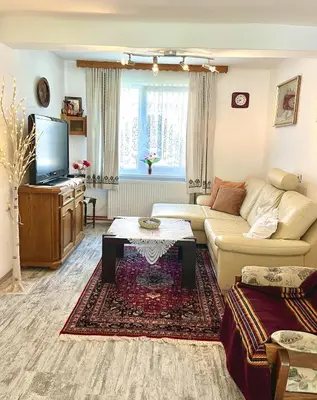 a living room with a couch and a tv at Green Village Life in Katun