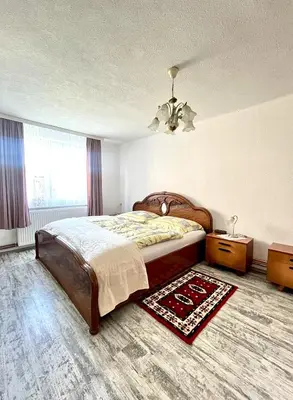 a bedroom with a large bed and a chandelier at Green Village Life in Katun