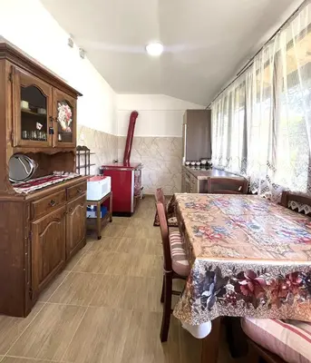 a dining room with a table and a kitchen at Green Village Life in Katun