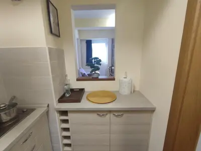 a small kitchen with a sink and a mirror at Suncani apartman 36, Brzece in Brzeće