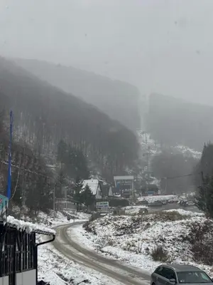 a snow covered road with a car on a mountain at BELE STAZE 18 - BRZEĆE KOPAONIK in Brzeće