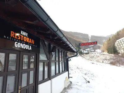 a building with a sign on the side of a mountain at BELE STAZE 18 - BRZEĆE KOPAONIK in Brzeće