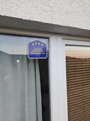 a blue sign on the side of a building at Kucica na brdu in Zaječar