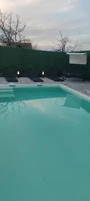 a swimming pool with a reflection in the water at Kucica na brdu in Zaječar