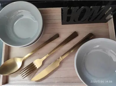a wooden tray with utensils on a table at Kucica na brdu in Zaječar