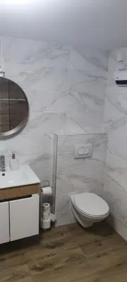 a bathroom with a toilet and a sink and a mirror at Kucica na brdu in Zaječar