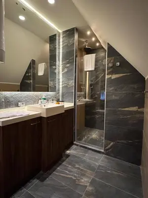 a bathroom with two sinks and a shower at KULA ANDJELA KONACI - Kopaonik Ski Centar in Kopaonik