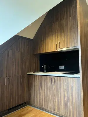 a kitchen with wooden cabinets and a sink at KULA ANDJELA KONACI - Kopaonik Ski Centar in Kopaonik