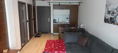a living room with a couch and a table at Apartman 1001 noc - Zoned 2 in Kopaonik