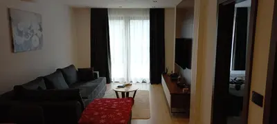a living room with a couch and a table at Apartman 1001 noc - Zoned 2 in Kopaonik