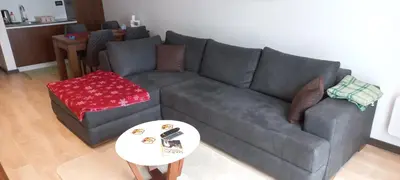 a living room with a gray couch and a table at Apartman 1001 noc - Zoned 2 in Kopaonik