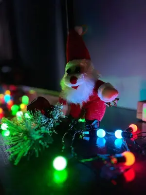 a santa claus figurine on a table with christmas lights at Vila MMBS in Brzeće