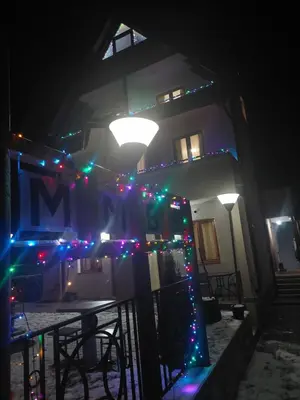 a house with christmas lights on it at night at Vila MMBS in Brzeće