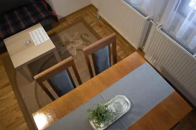 a table and chairs in a room with a table and a table at Vila MMBS in Brzeće