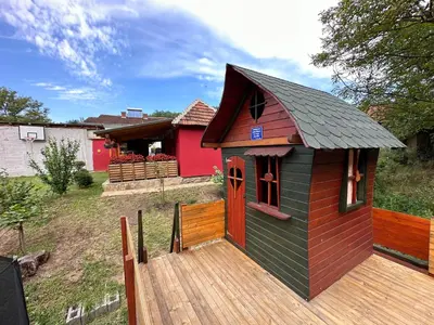 a small play house on a wooden deck at Etno kuća Trifunović in Pretrešnja