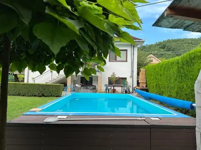 a swimming pool in the backyard of a house at Etno kuća Trifunović in Pretrešnja