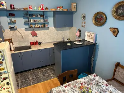 a kitchen with blue cabinets and a counter top at Etno kuća Trifunović in Pretrešnja