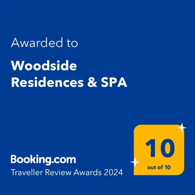 a yellow sign with the text awarded to woodsidereserved reserves and spa at Woodside Residences & SPA in Kopaonik