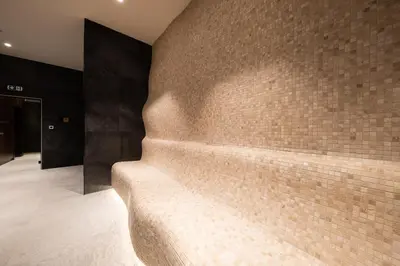 a brick wall in a room with a couch at Woodside Residences & SPA in Kopaonik