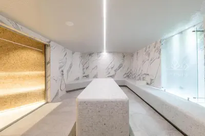 a room with a stone bench in front of a wall at Woodside Residences & SPA in Kopaonik