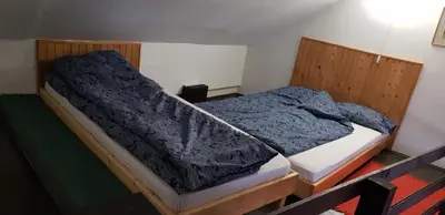 a bedroom with a bed with a blanket on it at Bele Staze 84, Ski tavanče, Brzeće in Brzeće