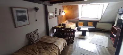 a bedroom with a bed and a chair and a window at Bele Staze 84, Ski tavanče, Brzeće in Brzeće