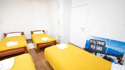 a room with two beds and a sign that says its time to sell at Apartment miTski Kop in Kopaonik