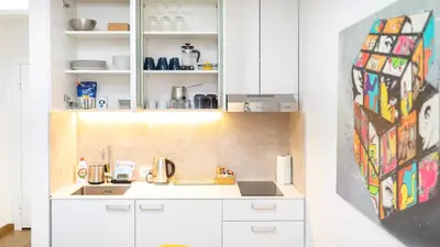 a kitchen with white cabinets and a sink at Apartment miTski Kop in Kopaonik