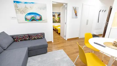 a living room with a couch and a table at Apartment miTski Kop in Kopaonik