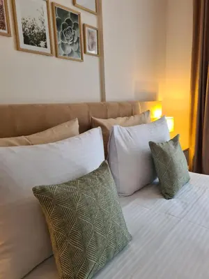 a bedroom with a bed with pillows and a couch at Mountain Side Kopaonik in Kopaonik